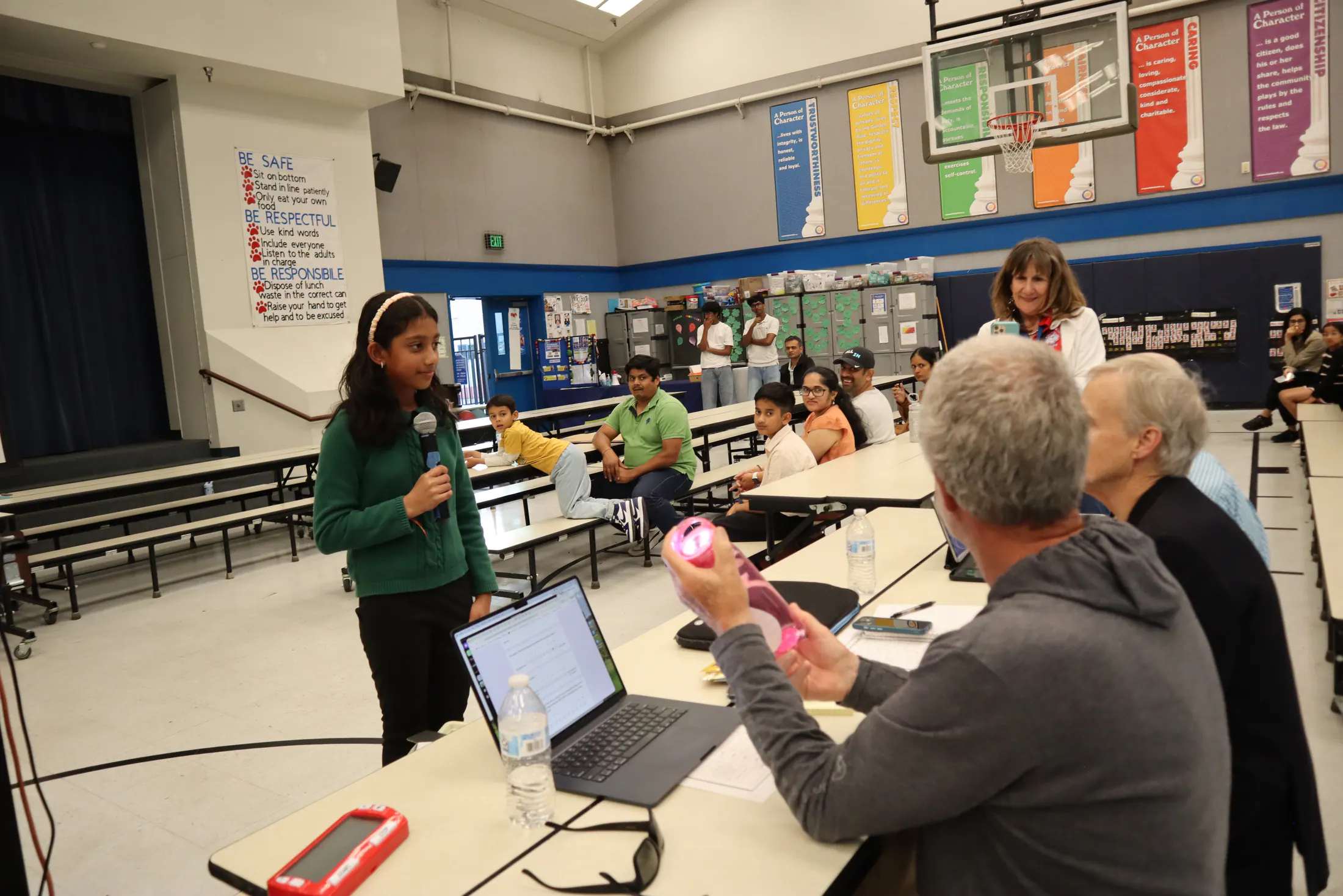 A student presents a project to seated judges at Wildcat Tank.