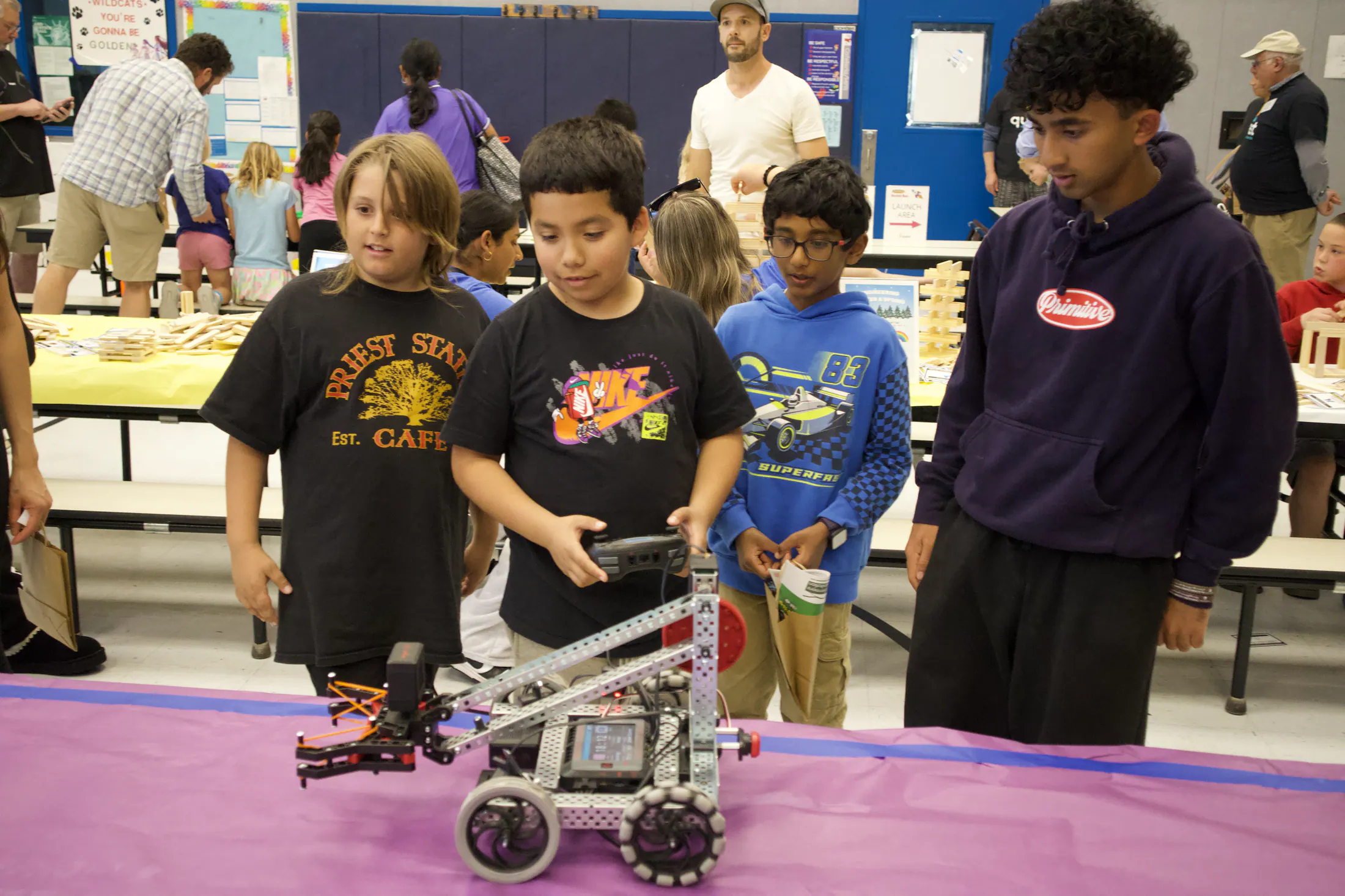 Families gathered around a table for a hands-on science activity.